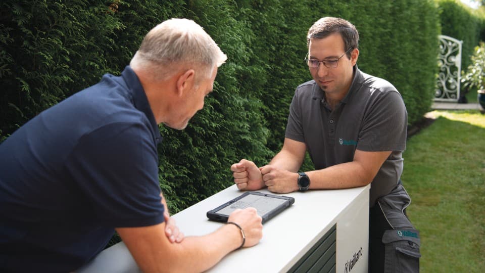 Installer and Vaillant service technician installing a heat pump.